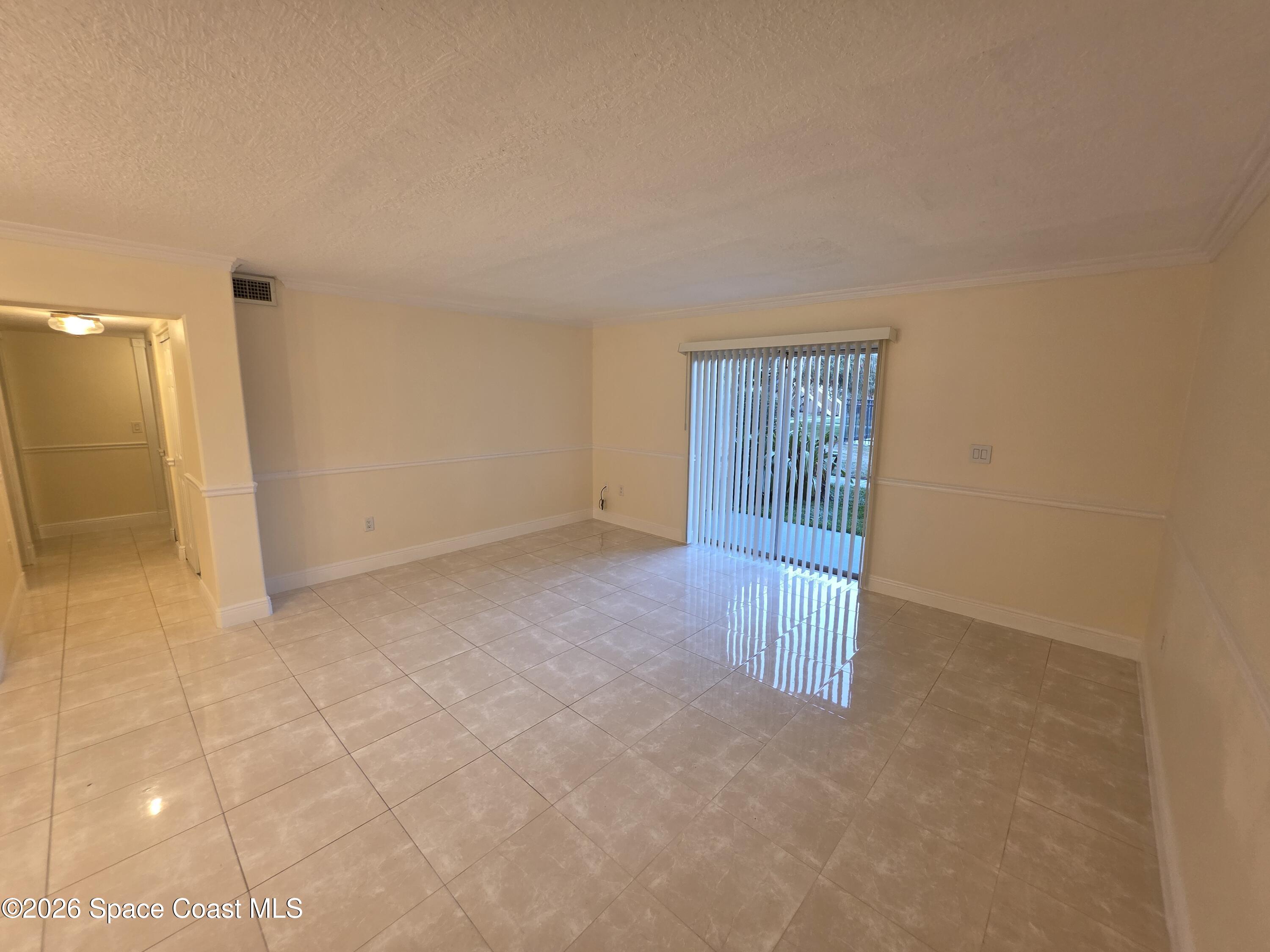 189 Cambridge Lane Melbourne, FL 32935 - Photo 2 of 14 a view of an empty room and window