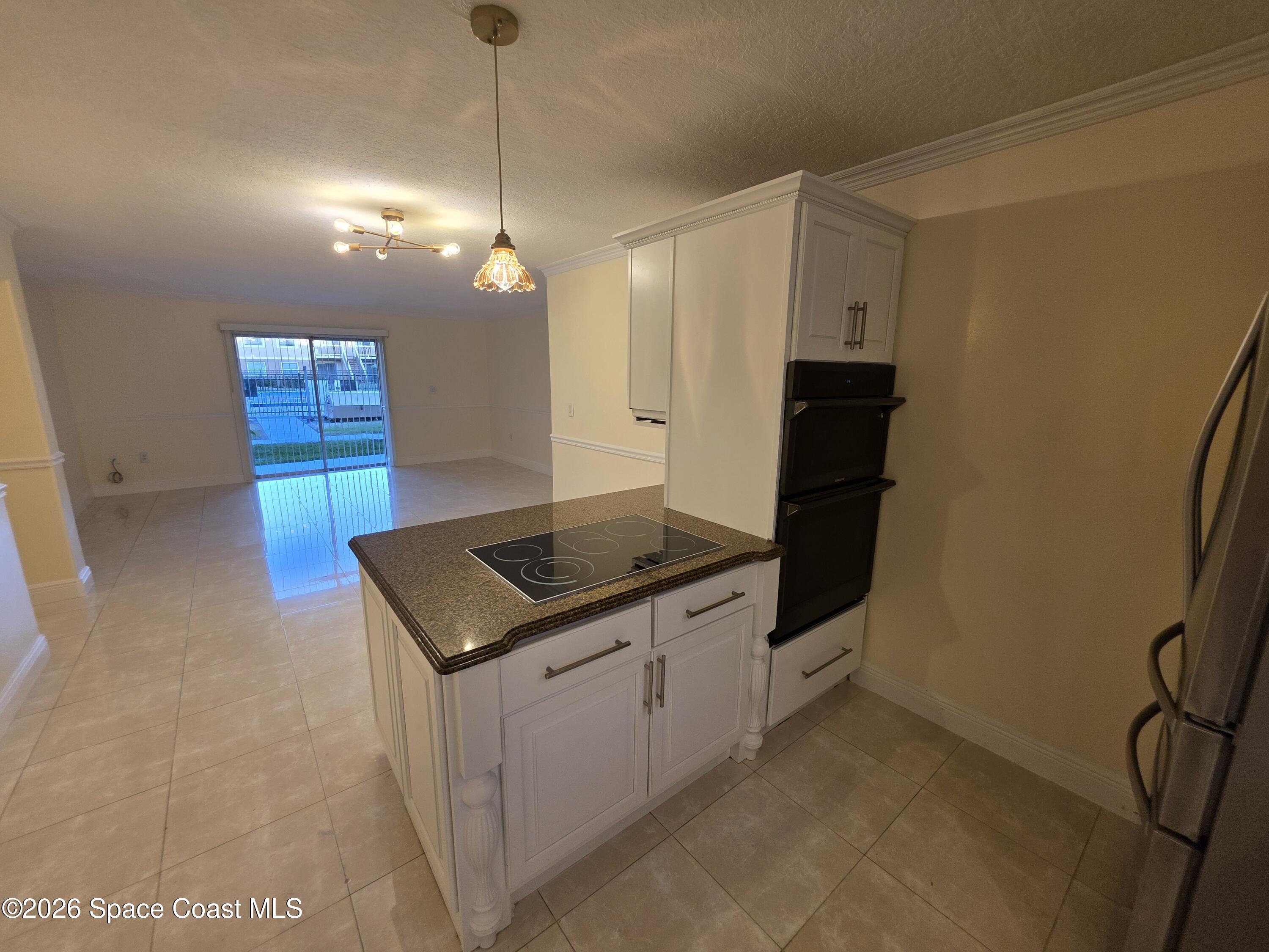 189 Cambridge Lane Melbourne, FL 32935 - Photo 6 of 14 a kitchen with stainless steel appliances granite countertop a sink a stove a refrigerator and island