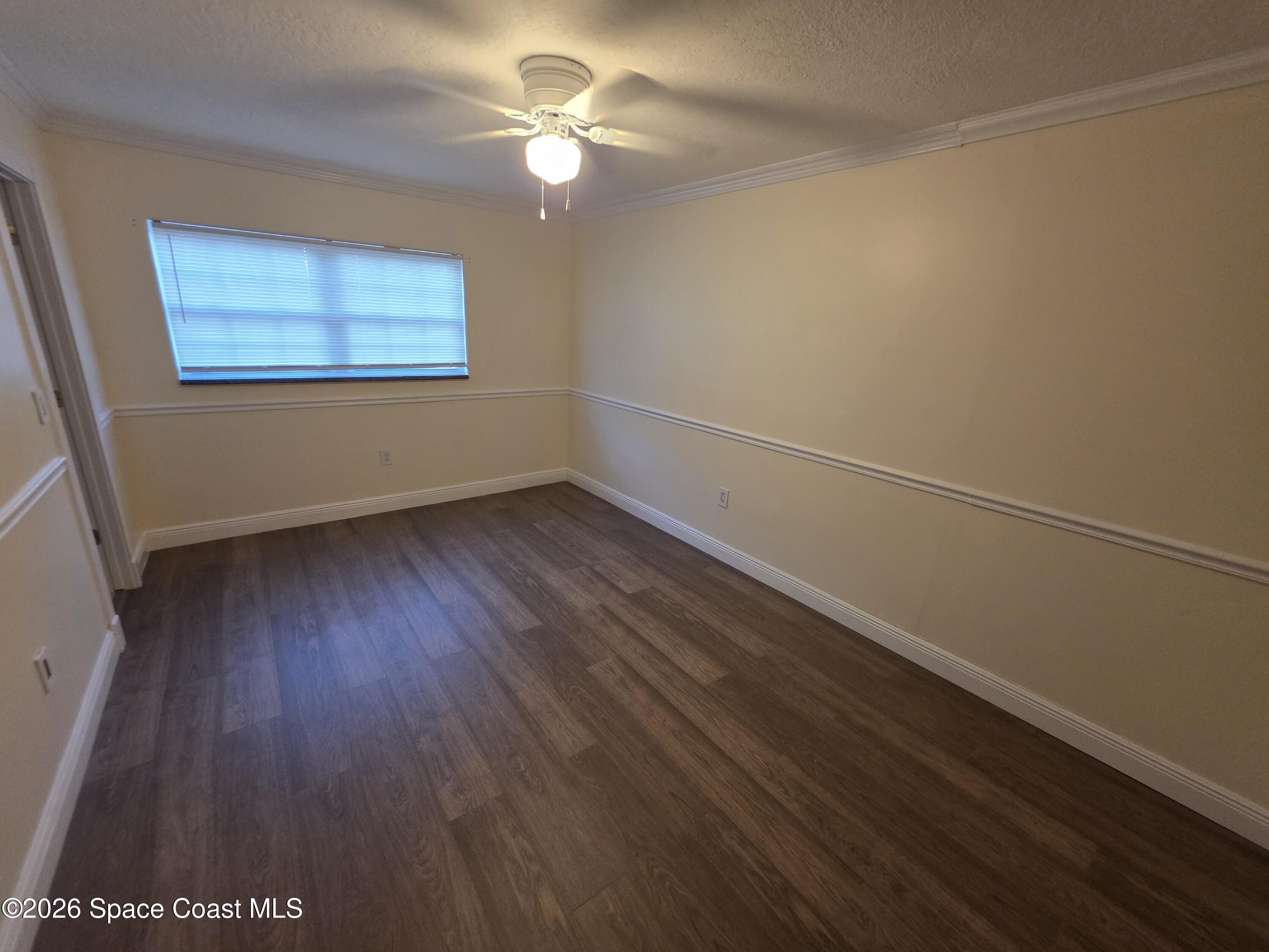 189 Cambridge Lane Melbourne, FL 32935 - Photo 9 of 14 wooden floor in an empty room with a window