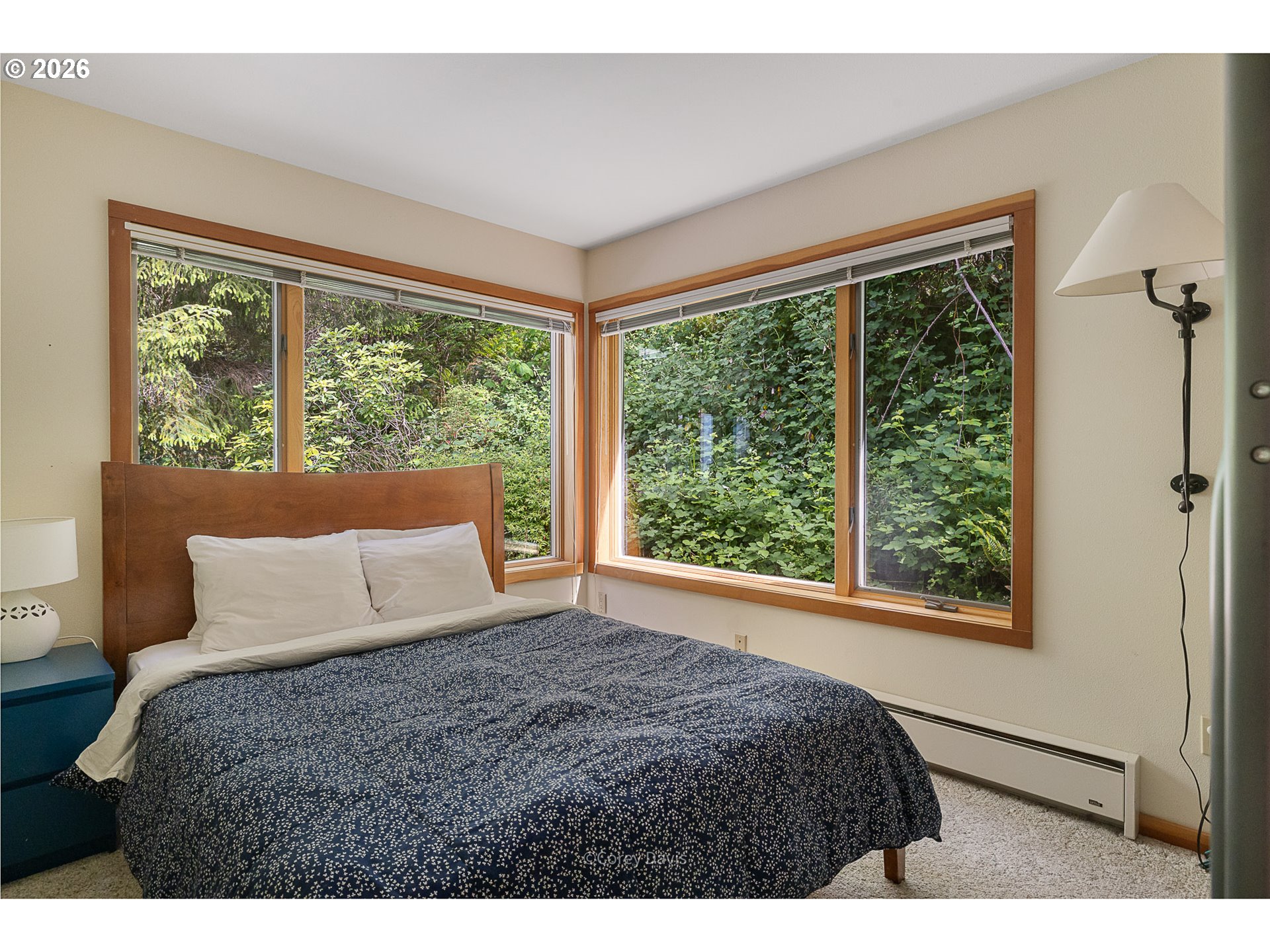 38295 Beulah Reed Road Nehalem, OR 97131 - Photo 39 of 42 a bedroom with a large window and a bed