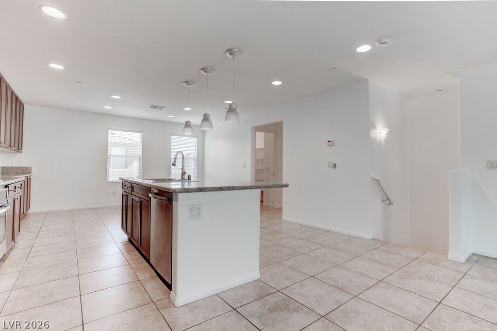 4650 Ranch House Road, Unit 47 North Las Vegas, NV 89031 - Photo 8 of 43 A contemporary kitchen space boasts an inviting island with granite counters and stylish pendant lighting.