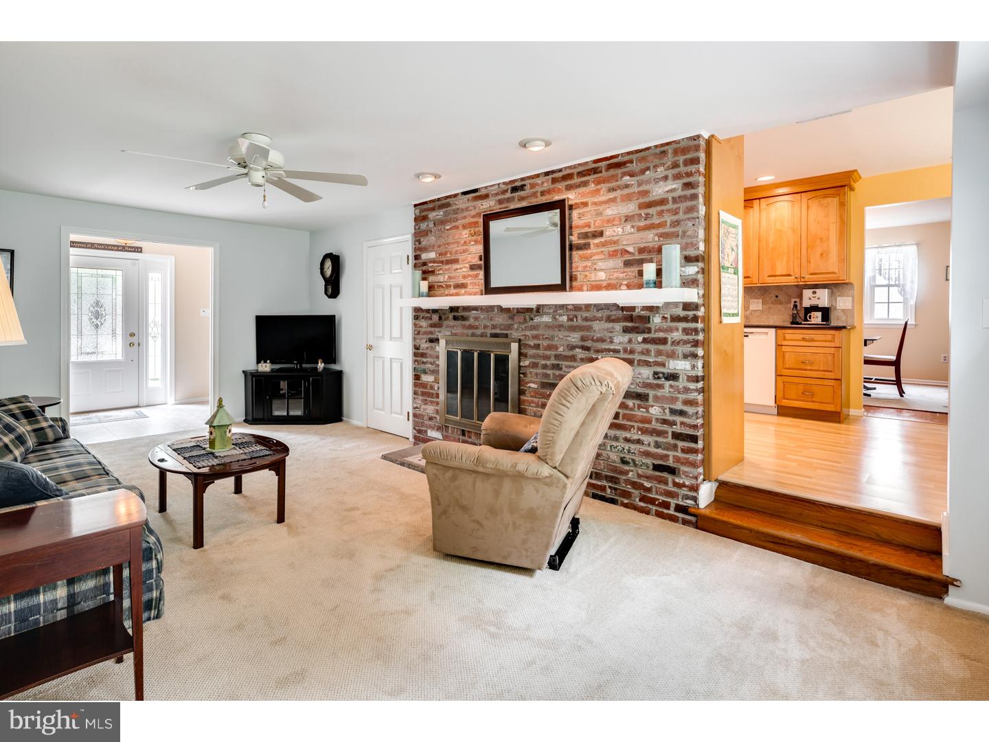 118 Fenwick Road Cherry Hill, NJ 08034 - Photo 11 of 24 a living room with furniture a fireplace and a flat screen tv