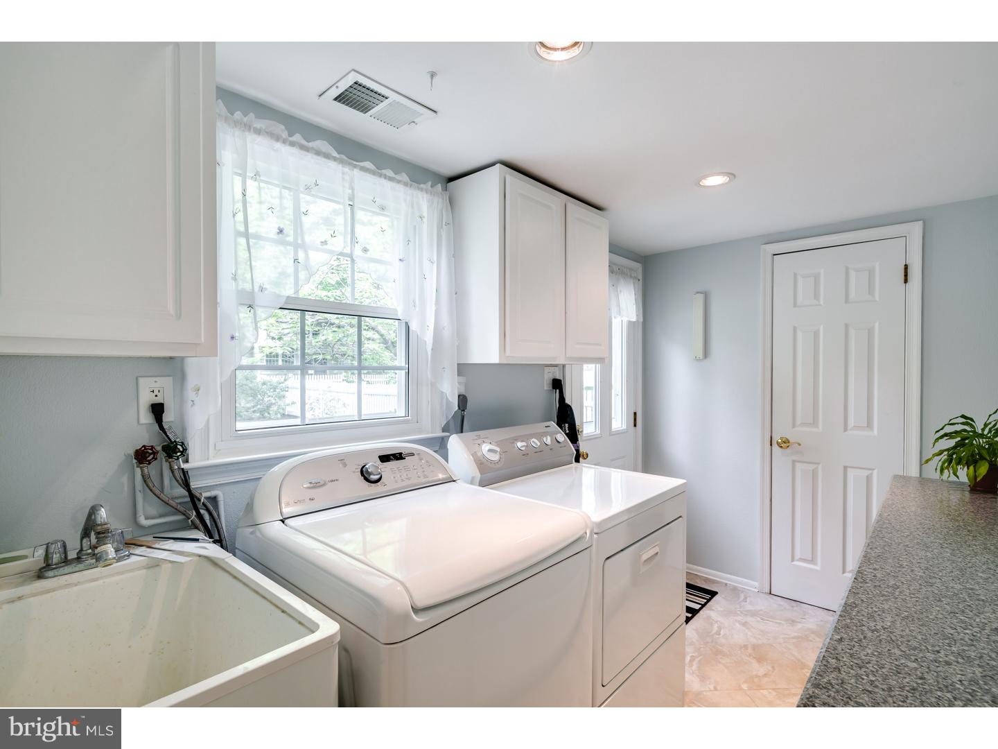 118 Fenwick Road Cherry Hill, NJ 08034 - Photo 13 of 24 a kitchen with a sink window and cabinets