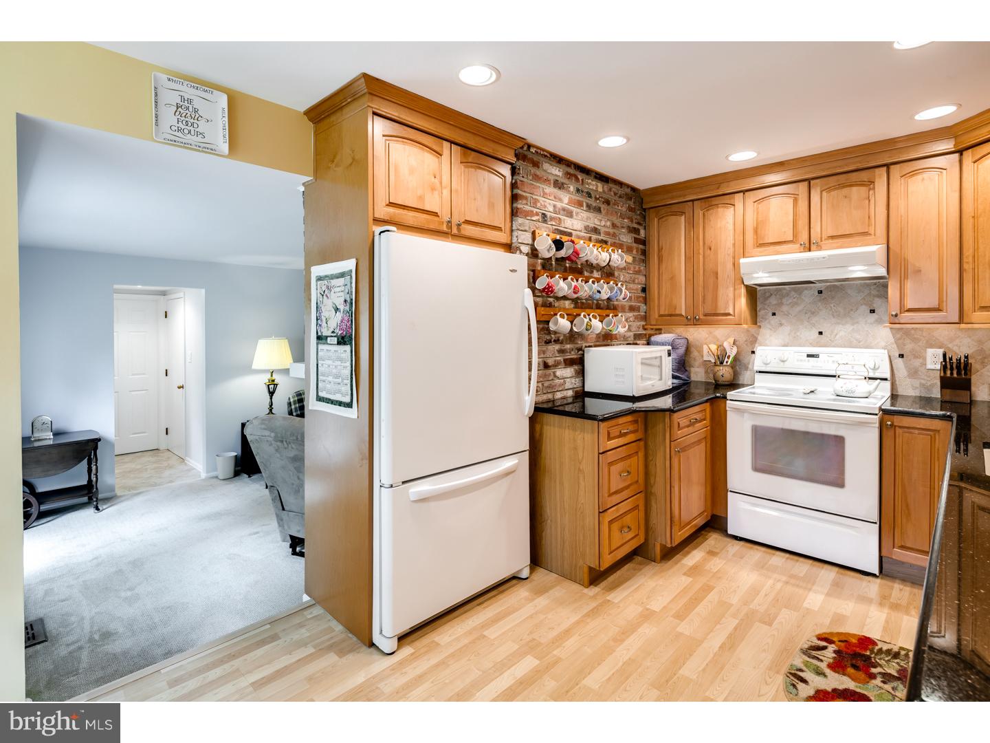 118 Fenwick Road Cherry Hill, NJ 08034 - Photo 9 of 24 a kitchen with a refrigerator sink and cabinets