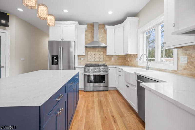 118 Cambridge Road Westfield, NJ 07090 - Photo 13 of 50 a kitchen with kitchen island white cabinets and stainless steel appliances