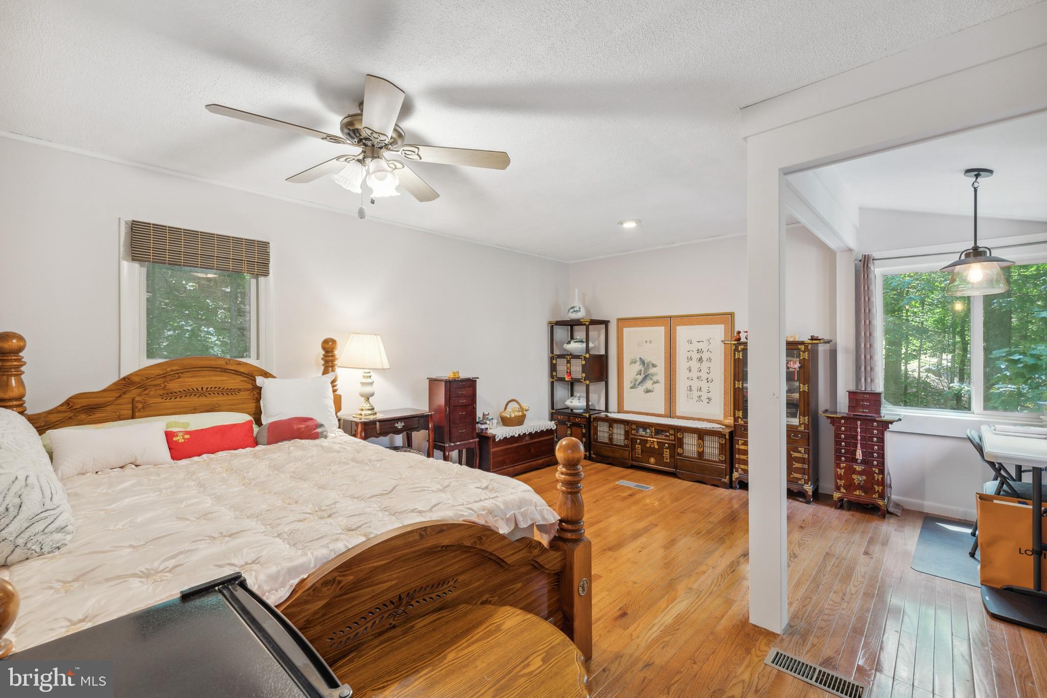 929 High Knob Road Front Royal, VA 22630 - Photo 18 of 30 a bedroom with a large bed and a chandelier