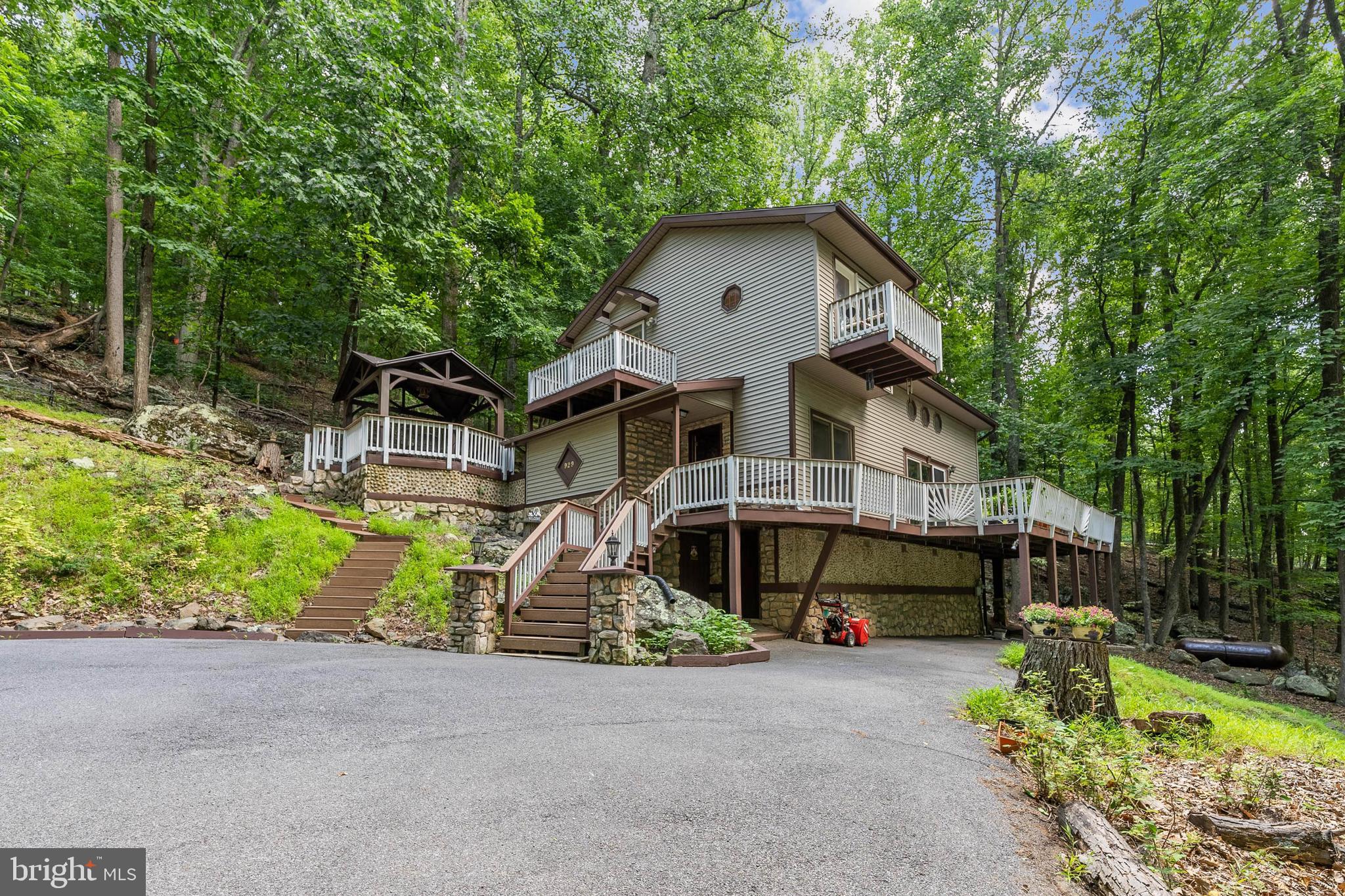 929 High Knob Road Front Royal, VA 22630 - Photo 3 of 30 a front view of a house with a yard and potted plants