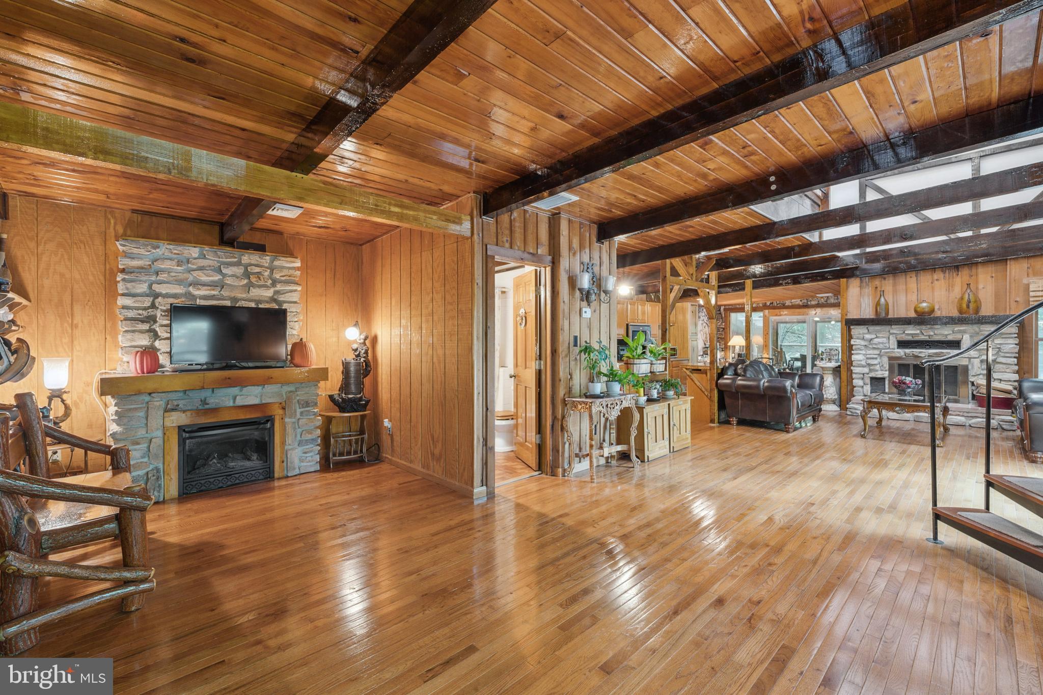 929 High Knob Road Front Royal, VA 22630 - Photo 5 of 30 a view of a livingroom with fireplace and a wooden floor