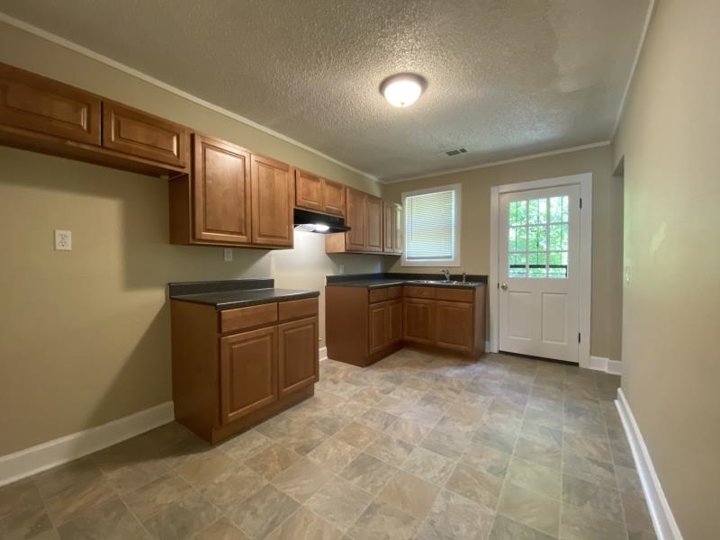 1534 Gabay Street Memphis, TN 38106 - Photo 4 of 8 a kitchen with a sink a stove and cabinets