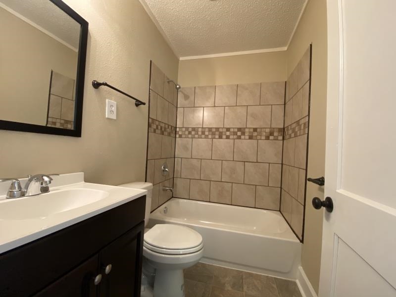 1534 Gabay Street Memphis, TN 38106 - Photo 6 of 8 a bathroom with a sink a toilet and shower