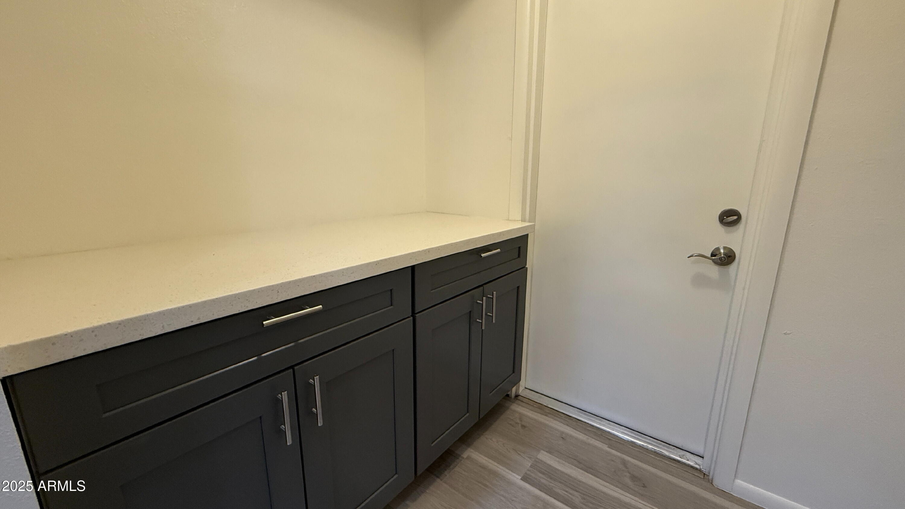 3707 West Alice Avenue Phoenix, AZ 85051 - Photo 13 of 27 a view of storage and utility room with wooden floor