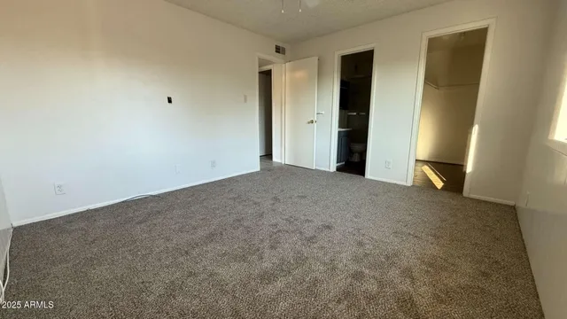 a view of an empty room and closet area