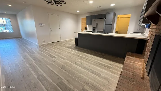 a kitchen with stainless steel appliances kitchen island granite countertop a sink dishwasher stove and cabinets