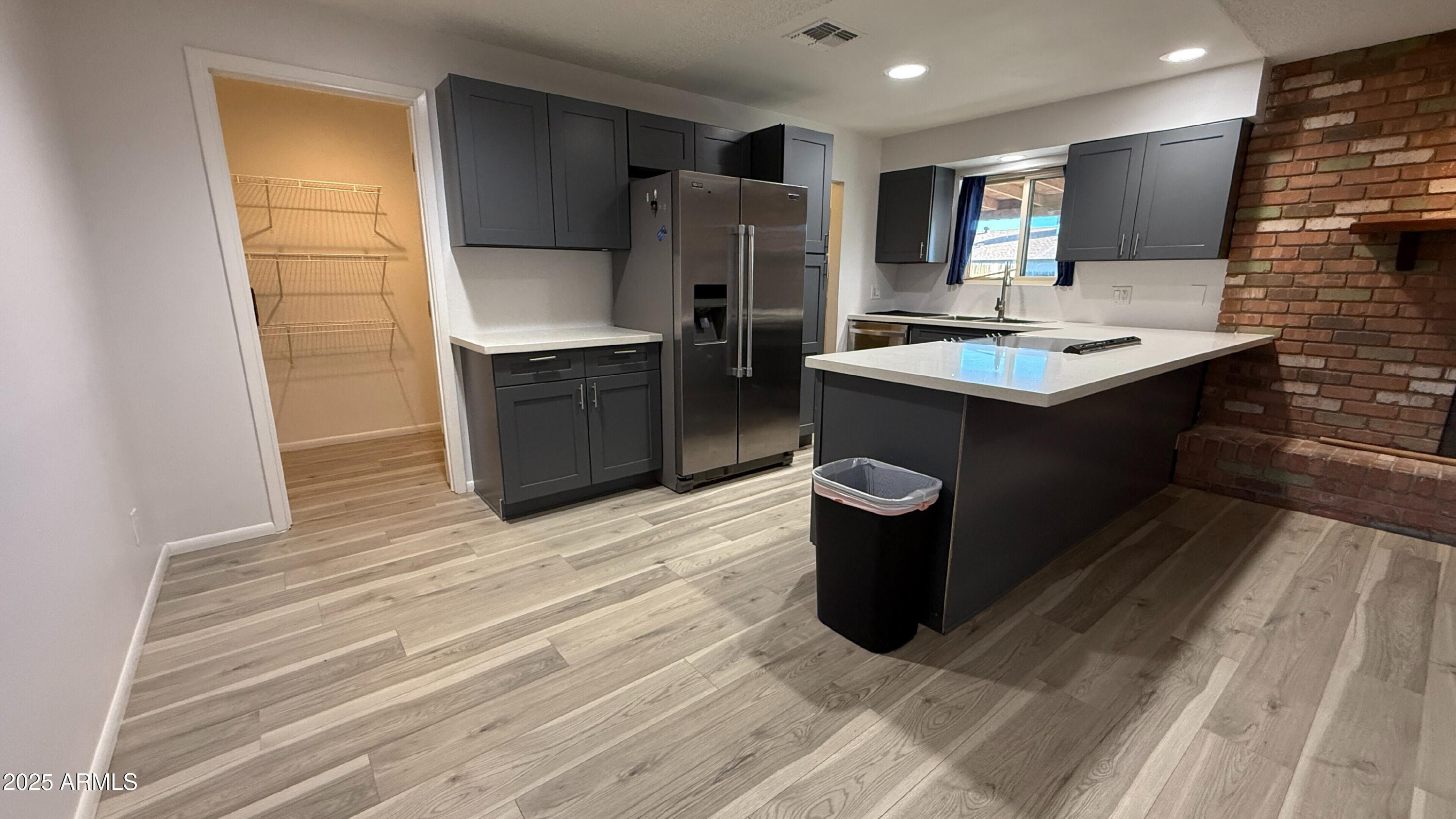 3707 West Alice Avenue Phoenix, AZ 85051 - Photo 8 of 27 a kitchen with a refrigerator and a sink