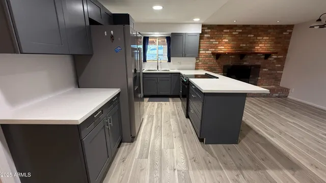 a kitchen with a sink and wooden cabinets