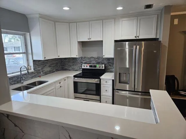 a kitchen with a refrigerator sink and stove