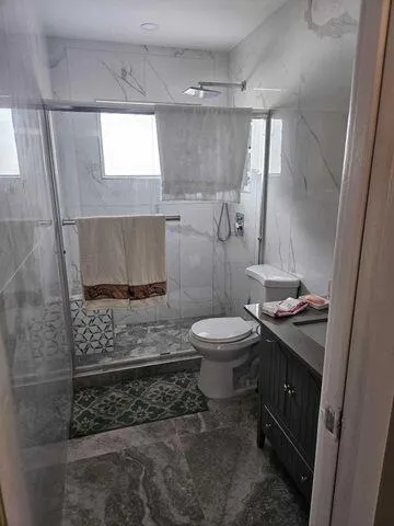 a bathroom with a toilet a sink and a window
