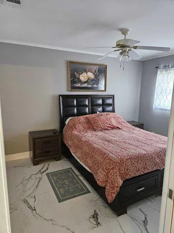 a bedroom with a bed and a window