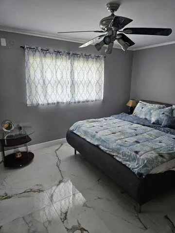 a bedroom with a bed and a window