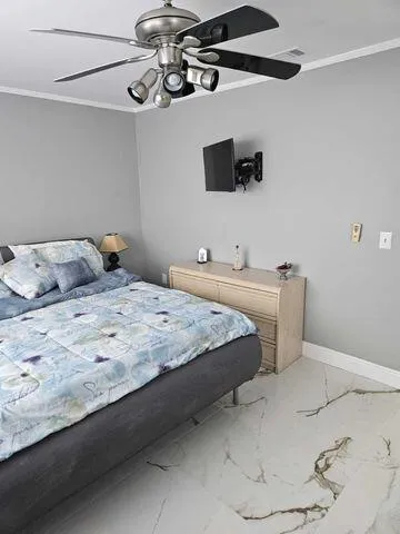 a bedroom with a bed and ceiling fan