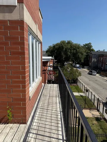 a balcony with wooden floor and city view
