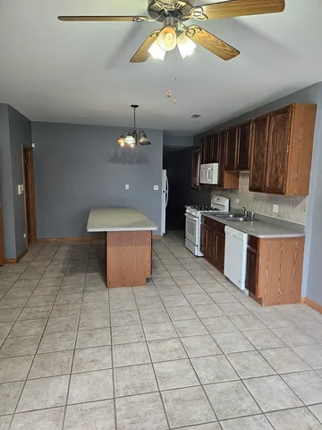 a kitchen with stainless steel appliances a sink a stove a microwave and cabinets