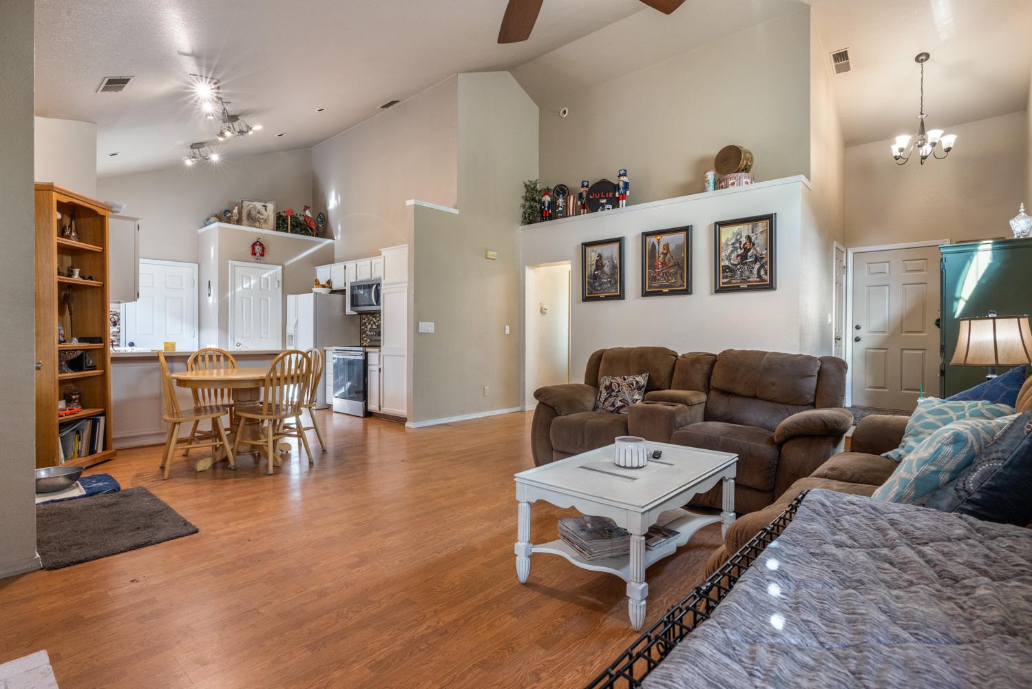 2812 Stone Terrace Modesto, CA 95355 - Photo 11 of 33 a living room with furniture and a dining table with wooden floor