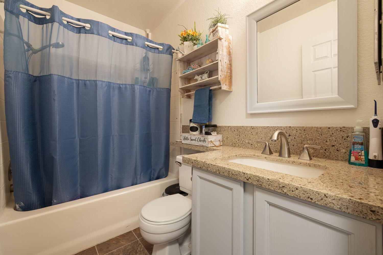 2812 Stone Terrace Modesto, CA 95355 - Photo 20 of 33 a bathroom with a granite countertop sink and a toilet