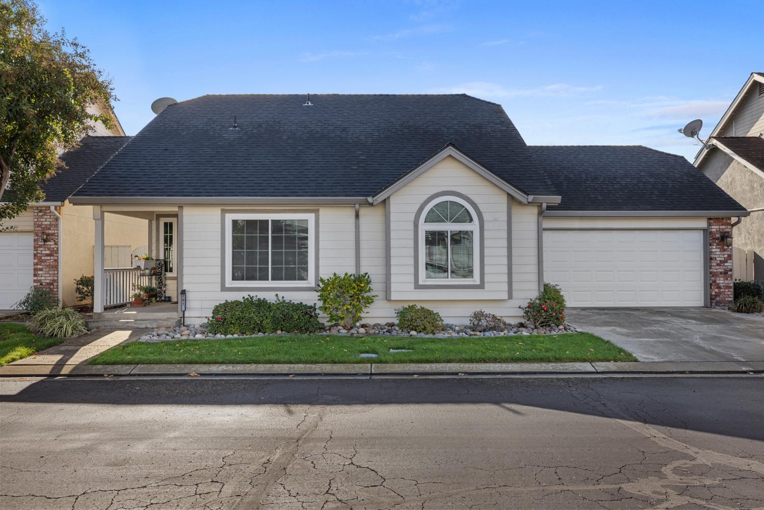2812 Stone Terrace Modesto, CA 95355 - Photo 4 of 33 a front view of a house with a garden and plants