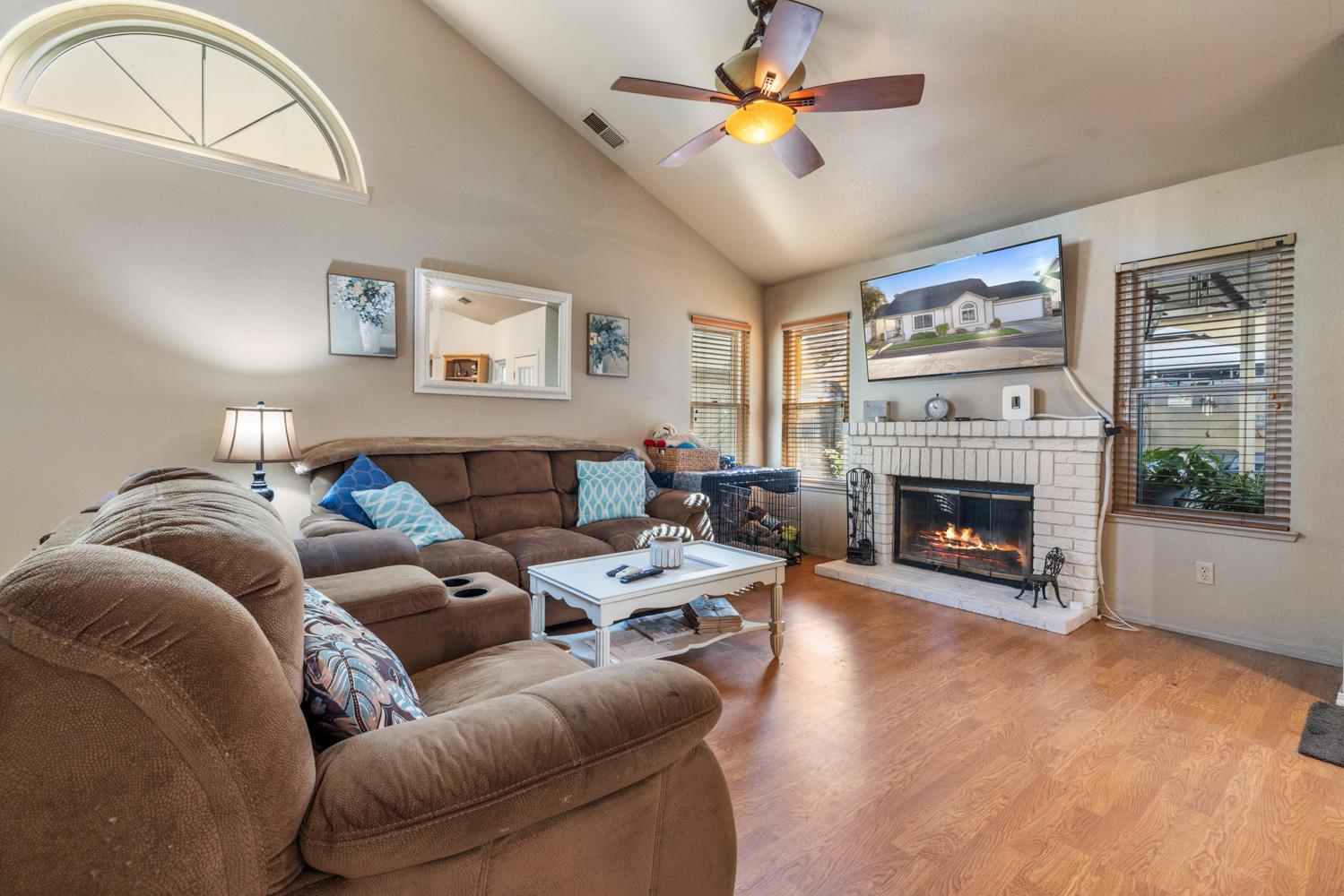 2812 Stone Terrace Modesto, CA 95355 - Photo 10 of 33 a living room with furniture a fireplace and a large window