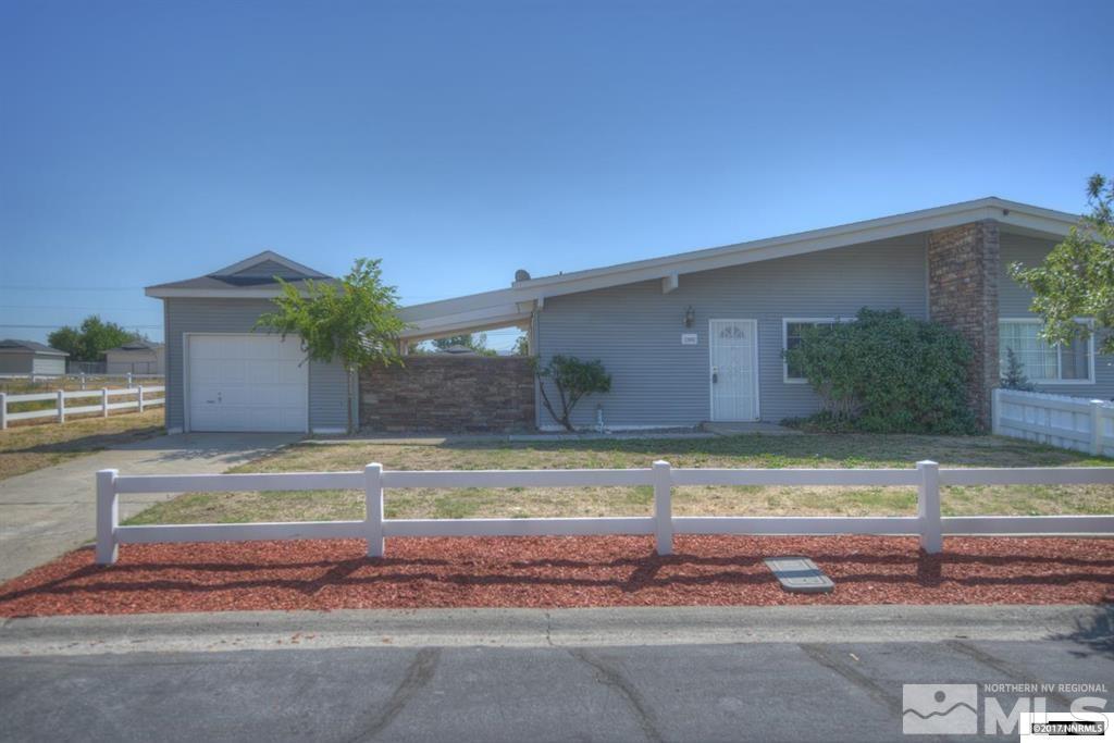 12002 Andes Street Reno, NV 89506 - Photo 1 of 12 a view of a house with a yard and a garage