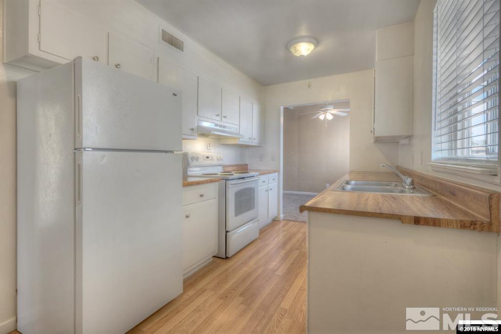 12002 Andes Street Reno, NV 89506 - Photo 9 of 12 a kitchen with a refrigerator a sink and a stove