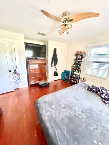 a view of spacious bedroom with a chandelier