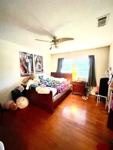 a bedroom with furniture and a large window