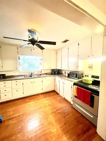 a kitchen with stainless steel appliances granite countertop a sink and cabinets