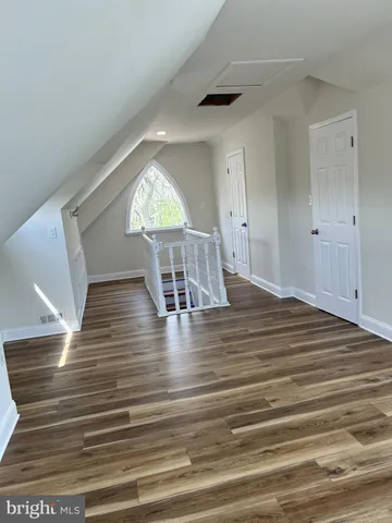 a view of a room with wooden floor window and staircase