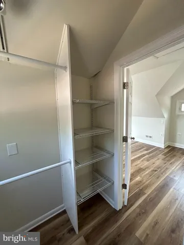 a view of walk in closet with empty racks