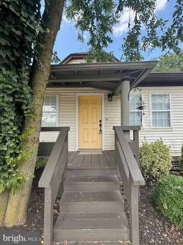 a front view of house with stairs