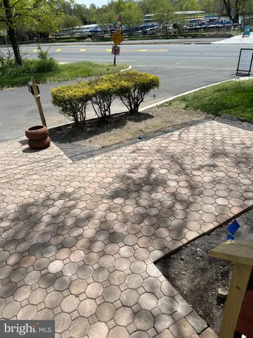 a view of a lake with a yard and large trees