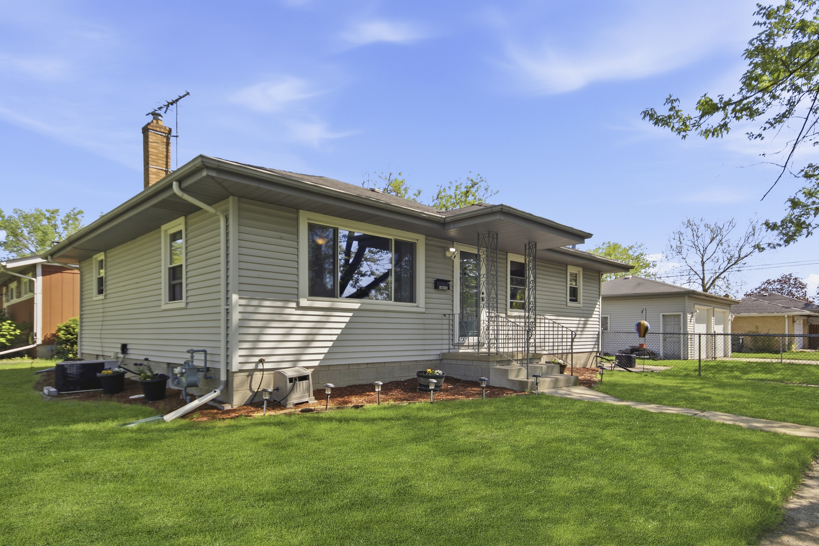 18655 Sherman Street Lansing, IL 60438 - Photo 2 of 21 a front view of a house with a garden