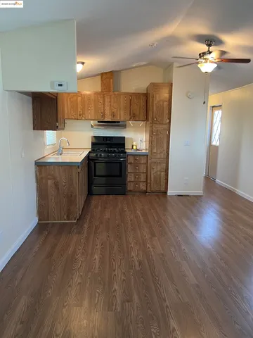 a kitchen with wooden cabinets and a stove top oven