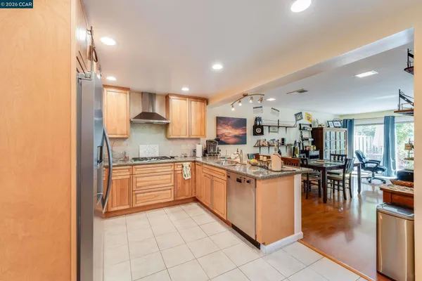 a bedroom with a large bed and a flat tv screen on dresser