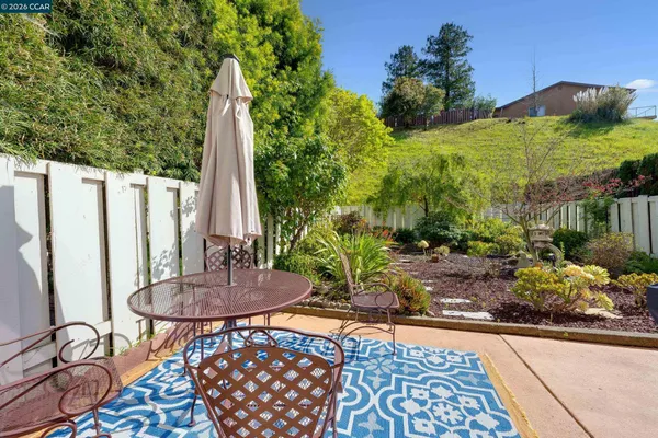 an aerial view of a house with yard and patio