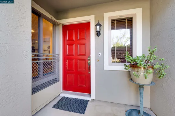 a view of a hallway with wooden floor and entryway