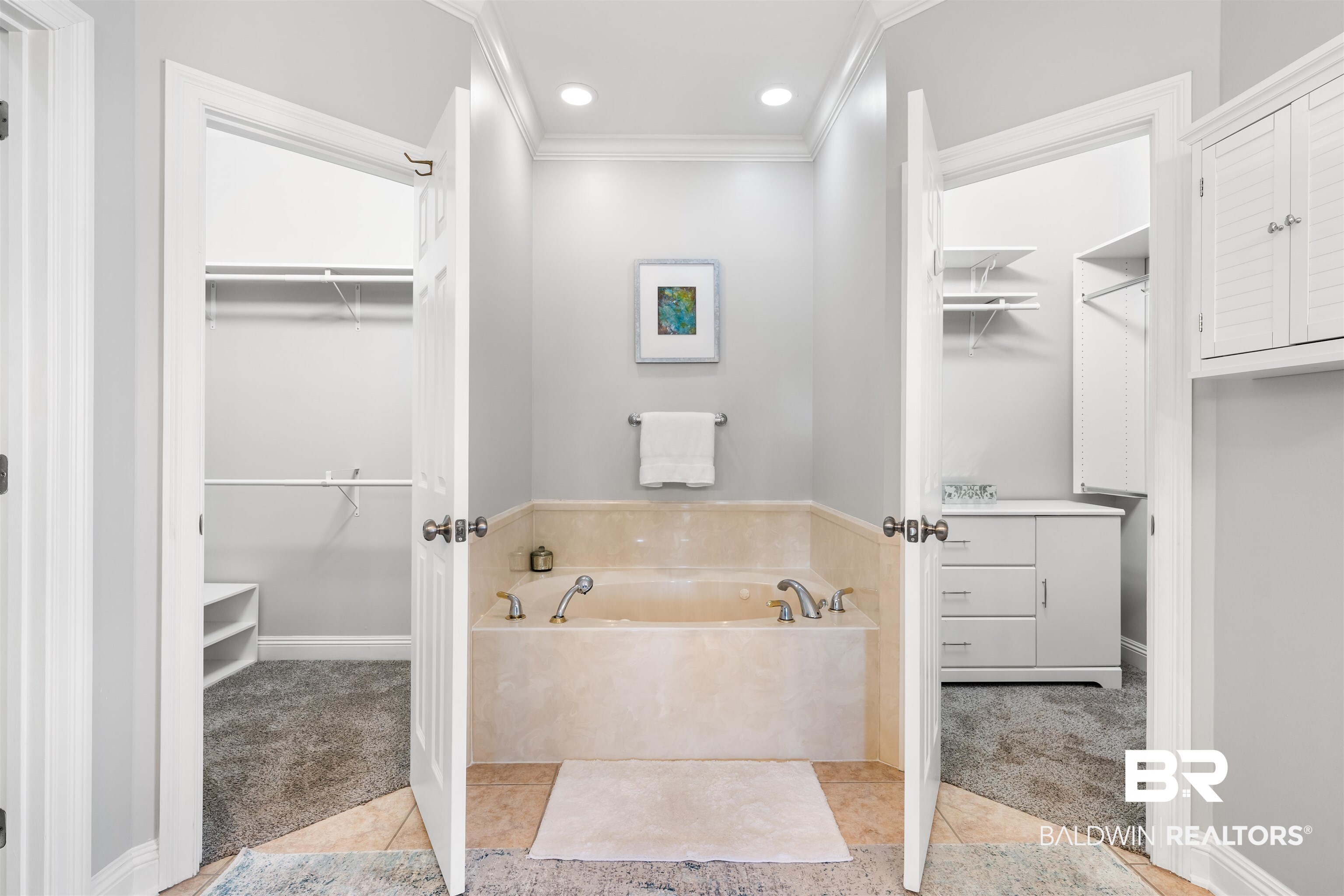 19079 Baldwin County Road 10 Foley, AL 36535 - Photo 20 of 37 Bathroom with a spacious closet, light carpet, a bath, light tile patterned floors, and ornamental molding