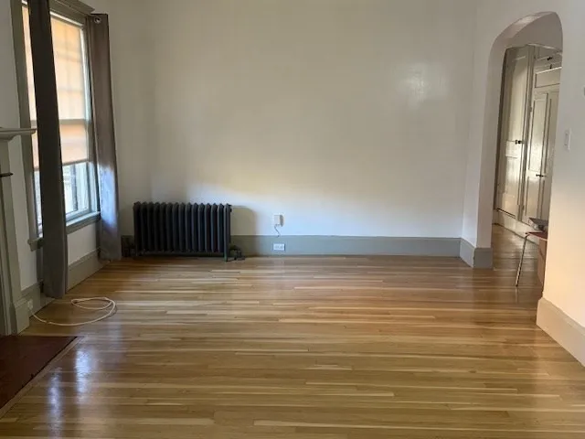 a view of an empty room and wooden floor