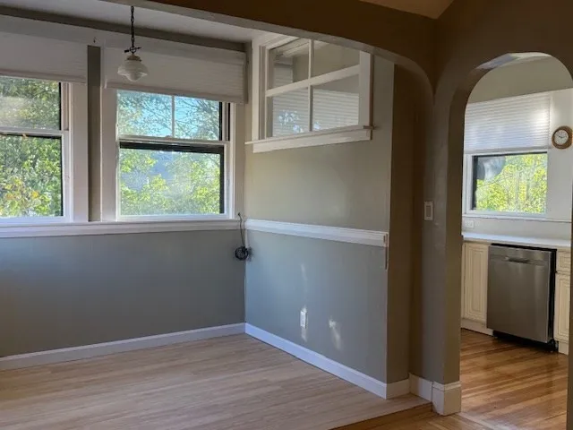an empty room with windows and closet