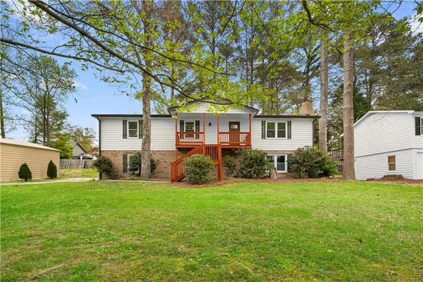 a front view of house with yard and green space