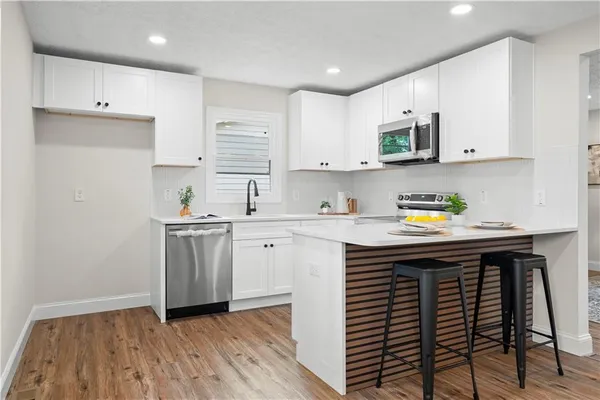 a kitchen with a sink stove and cabinets