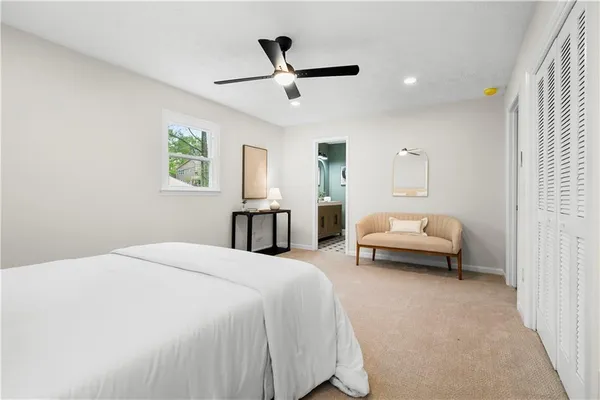 a bedroom with bed and window